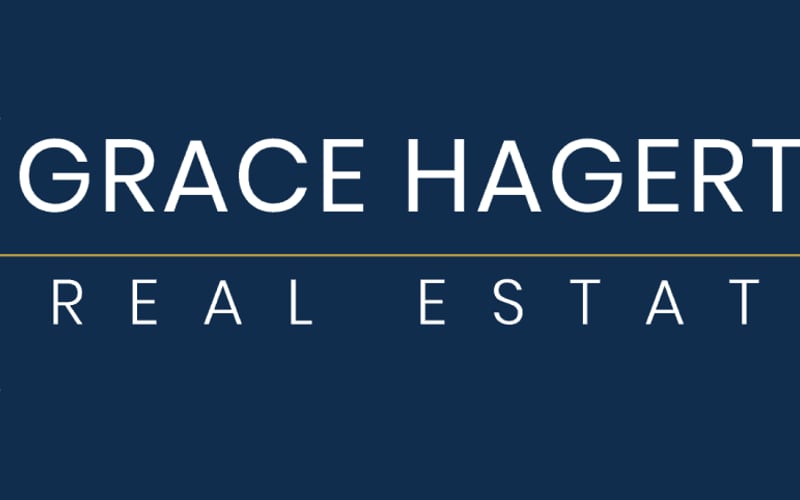 Grace Hagerty Real Estate logo with gold crosshairs on dark blue background